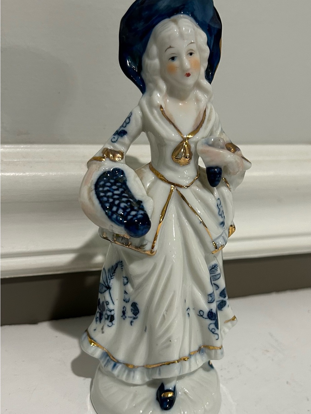 Victorian Lady in Formal Dress, Blue and White Figurine holding fruit